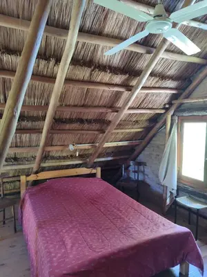 a bedroom with a bed and a ceiling fan at Cabaña Maitane in El Durazno