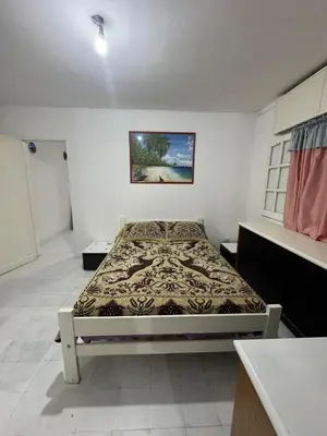 a bedroom with a bed in the corner of a room at Departamentos Las Termas de Brochero in Villa Cura Brochero