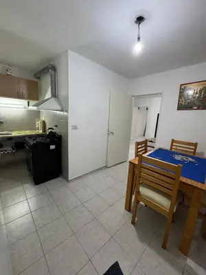 a kitchen with a table and a dining room at Departamentos Las Termas de Brochero in Villa Cura Brochero
