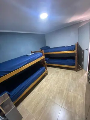 two bunk beds in a room with blue walls at Lo de joel in Villa Carlos Paz