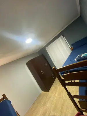 a small room with a bunk bed and a ladder at Lo de joel in Villa Carlos Paz