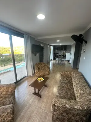 a living room with two couches and a table at Lo de joel in Villa Carlos Paz
