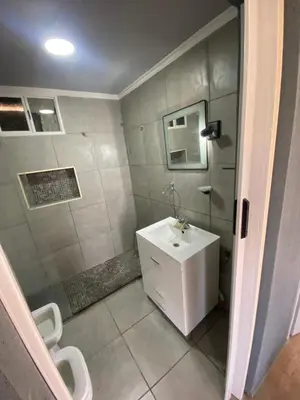 a bathroom with a white sink and a toilet at Lo de joel in Villa Carlos Paz