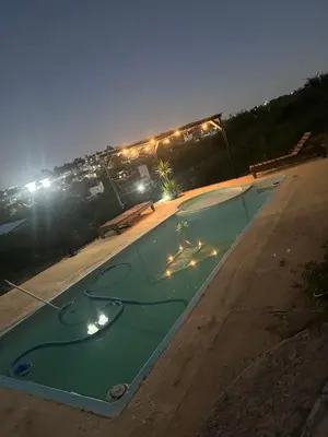 an empty swimming pool in a parking lot at night at Lo de joel in Villa Carlos Paz
