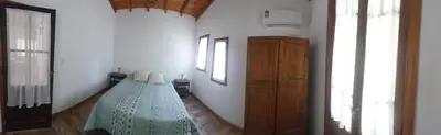 a room with two beds in the corner of a room at La arbolada in Villa Ciudad Parque