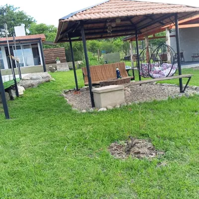 a park bench in a gazebo with a playground at Nápoles in Santa Rosa de Calamuchita