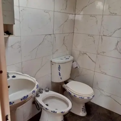 a bathroom with a toilet and a sink at Nápoles in Santa Rosa de Calamuchita