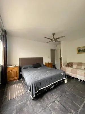 a bedroom with a bed and a ceiling fan at Casa Rumipal in Villa Rumipal