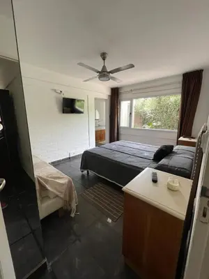 a bedroom with a bed and a ceiling fan at Casa Rumipal in Villa Rumipal