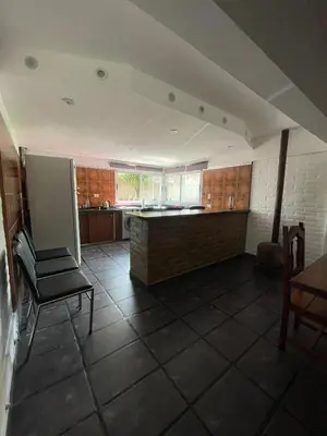 a kitchen with a table and a chair in a room at Casa Rumipal in Villa Rumipal