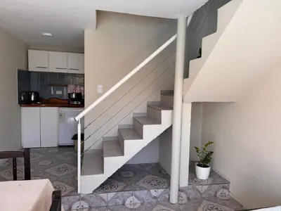 a staircase in a house with a kitchen at Las Casitas de Euge in Villa Carlos Paz