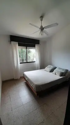 a bedroom with a bed and a ceiling fan at Gran Malvina in Villa Carlos Paz