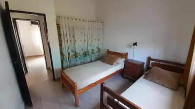 a bedroom with two beds and a door to a room at Gran Malvina in Villa Carlos Paz
