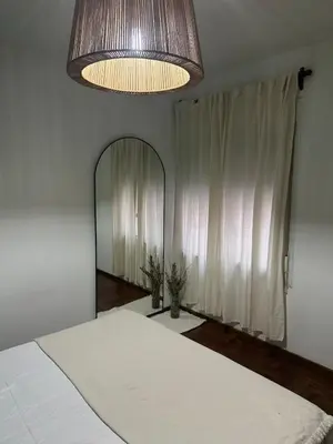 a bedroom with a bed and a large mirror at Carlis Home in Cordoba