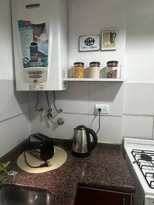 a kitchen counter with a tea kettle and a stove at Carlis Home in Cordoba