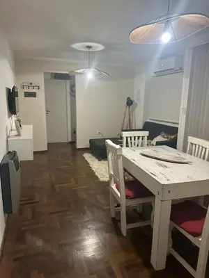 a living room with a table and a couch at Carlis Home in Cordoba