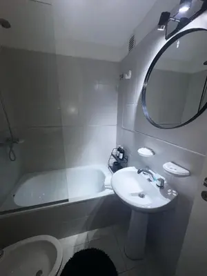 a bathroom with a sink and a tub and a mirror at Carlis Home in Cordoba