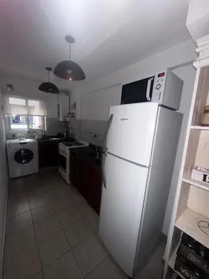 a kitchen with a white refrigerator and a stove at Carlis Home in Cordoba