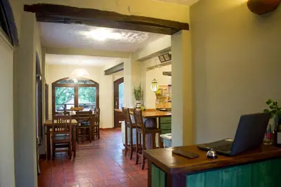 a kitchen and dining room with a laptop on a table at Posada serrana boutique con excelentes vistas cerca de arroyos y senderos y a 5 minutos de Merlo in El Rincón