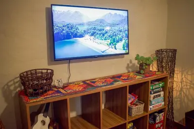 a flat screen tv hanging on a wall at Posada serrana boutique con excelentes vistas cerca de arroyos y senderos y a 5 minutos de Merlo in El Rincón