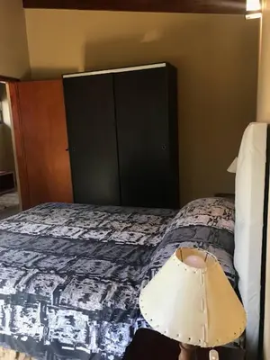 a bedroom with a bed with a lamp on it at Departamento Los Gigantes in Villa Carlos Paz