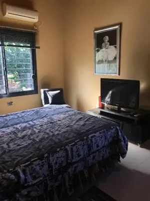 a bedroom with a bed and a flat screen tv at Departamento Los Gigantes in Villa Carlos Paz