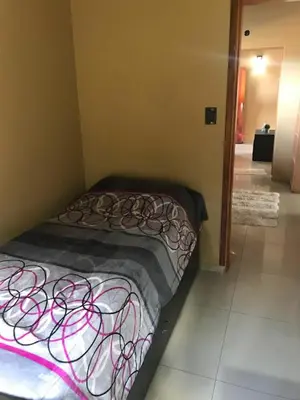 a small bed in a corner of a room at Departamento Los Gigantes in Villa Carlos Paz