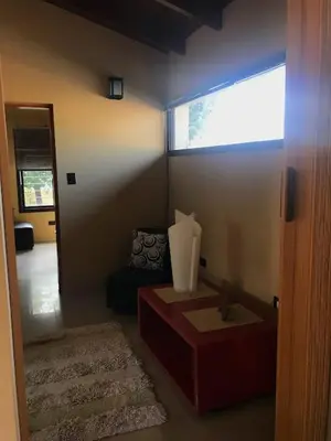 a living room with a table and a window at Departamento Los Gigantes in Villa Carlos Paz