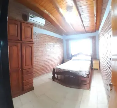 a bedroom with a bed in a brick wall at Complejo Cuarto Menguante in Arroyo de Los Patos