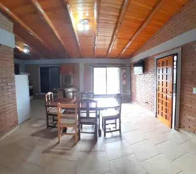 a dining room with a table and some chairs at Complejo Cuarto Menguante in Arroyo de Los Patos