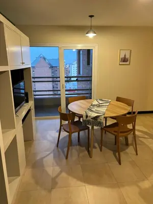 a kitchen and dining room with a table and chairs at Departamento amoblado 1 dormitorio Río 4 in Río Cuarto