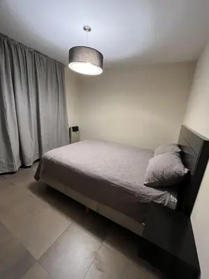 a bedroom with a bed and a light at Departamento amoblado 1 dormitorio Río 4 in Río Cuarto