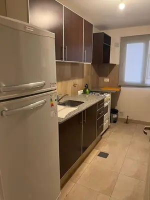 a kitchen with a refrigerator and a sink at Departamento amoblado 1 dormitorio Río 4 in Río Cuarto
