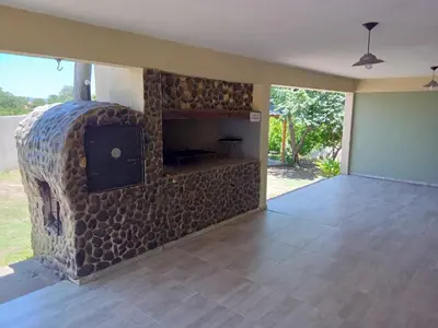 a living room with a stone wall with a fireplace at Casa florez in Mina Clavero