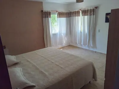a bedroom with a bed and a window at Casa florez in Mina Clavero