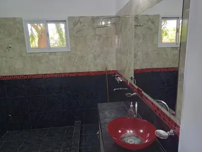 a bathroom with a red sink and a shower at Casa florez in Mina Clavero