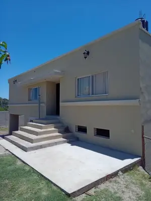 a white building with stairs in front of it at Casa florez in Mina Clavero