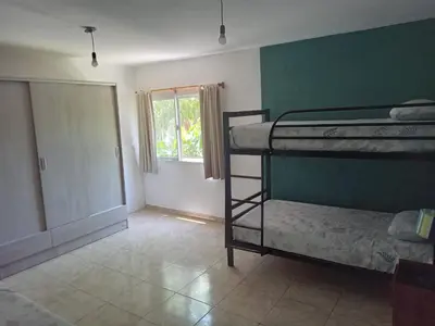 a room with two bunk beds and a window at Casa florez in Mina Clavero