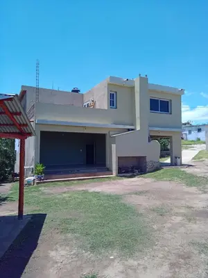 a house with a large garage in front of it at Casa florez in Mina Clavero