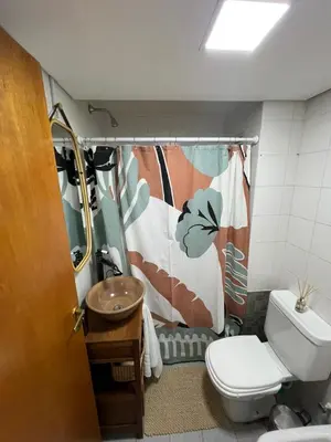 a bathroom with a toilet and a shower curtain at illia home in Cordoba