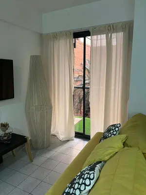 a bedroom with a bed and a large window at illia home in Cordoba