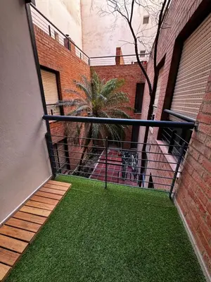 a balcony of a building with green grass at illia home in Cordoba