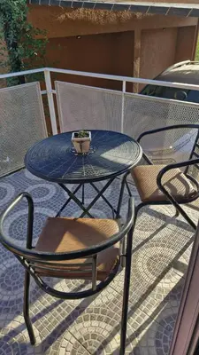 a table and chairs sitting on a patio at Dúplex La Delfina 3 in Villa Carlos Paz
