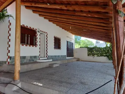 an open porch of a house with a wooden roof at Propiedades Centro MC in Mina Clavero