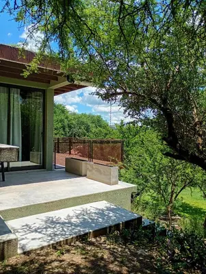 a patio with a bench on the side of a house at Refugio Verde en Nono, Córdoba in Nono