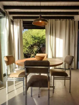 a dining room with a table and some chairs at Refugio Verde en Nono, Córdoba in Nono