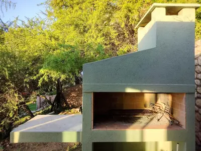 a brick oven in the side of a house at Refugio Verde en Nono, Córdoba in Nono