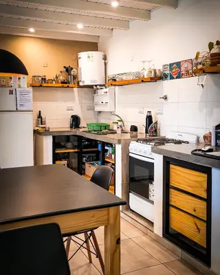 a kitchen with a stove and a table in it at Casa Moraa in Nono