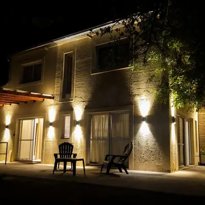 two chairs sitting in front of a building at night at Casa Moraa in Nono