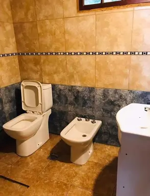 a bathroom with a toilet and a sink at Vistas valle in Santa Rosa de Calamuchita